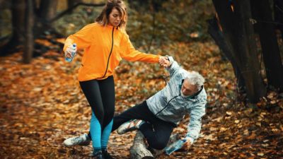 woman holding man's hand as he falls representing ups and downs of ASX investing