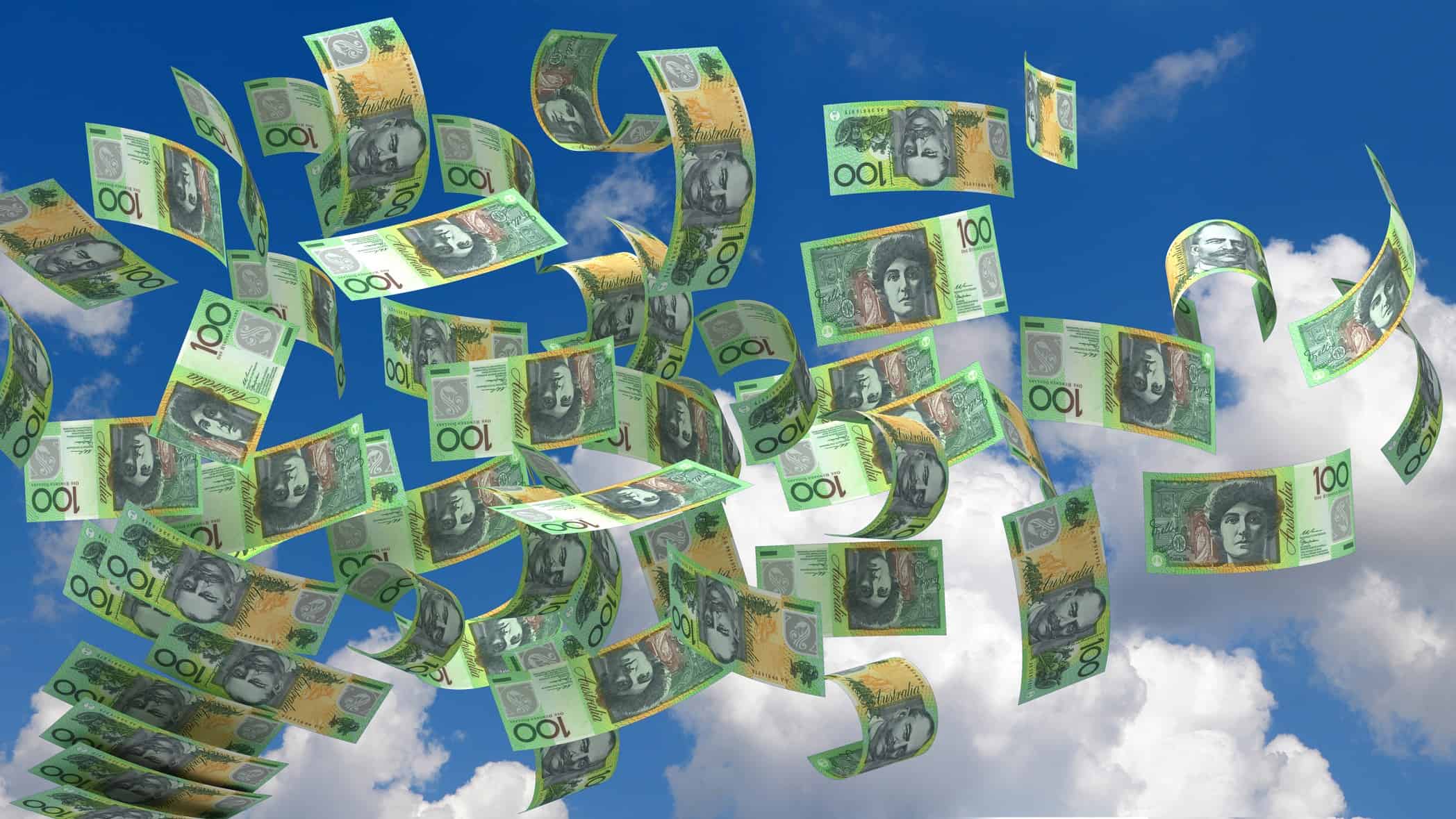 one hundred dollar notes blowing in the wind representing dividend windfall