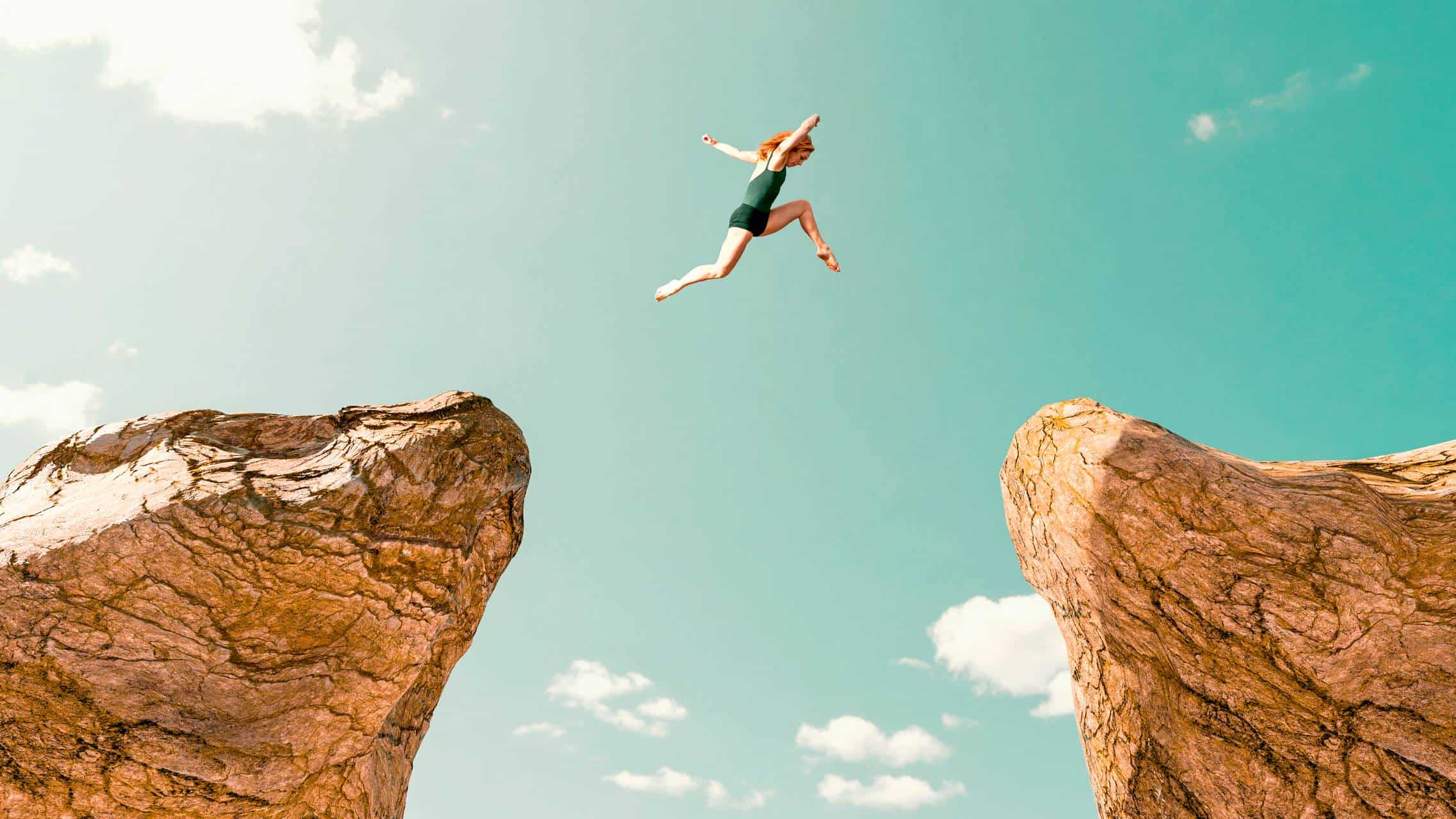 A female athlete in green spandex leaps from one cliff edge to another representing 3 ASX shares that are destined to rise and be great