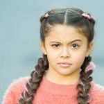 A girl is looking very confused, with one eyebrow raised saying what?