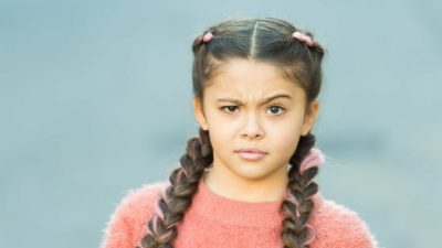 A girl is looking very confused, with one eyebrow raised saying what?