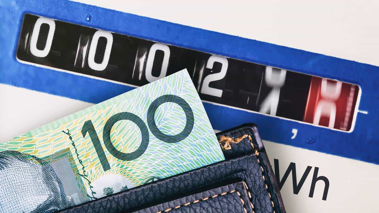 A wallet with a one hundred dollar bill poking out sits on top of an electricity meter with the numbers rapidly going up, representing power prices in Australia rising as we ponder whether the Origin Energy share price will go up as a result