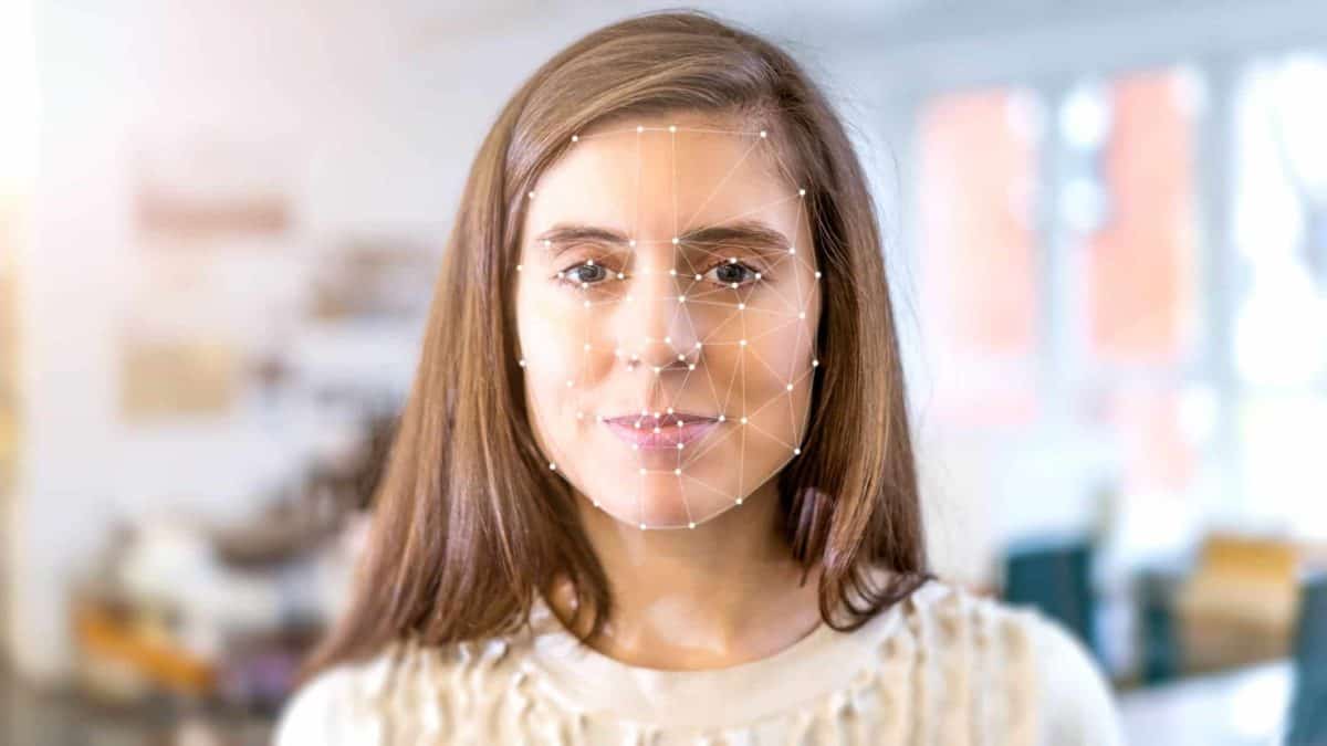 A woman's face is superimposed with the lines and point markings of facial recognition technology.