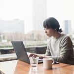 Woman at computer in office with a view