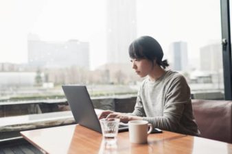 Woman at computer in office with a view