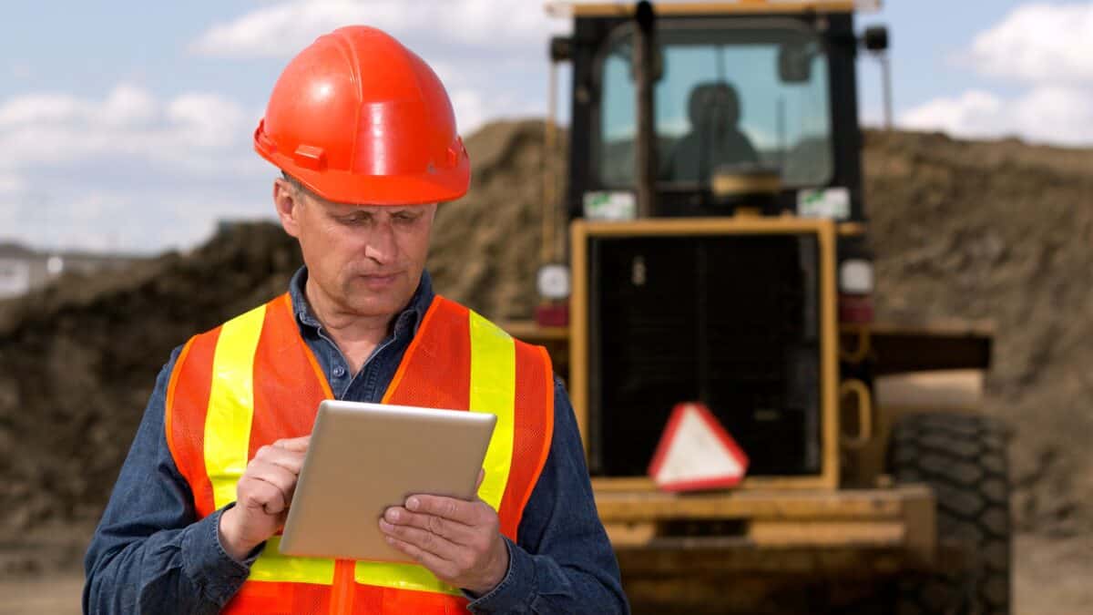 Miner looking at a tablet.
