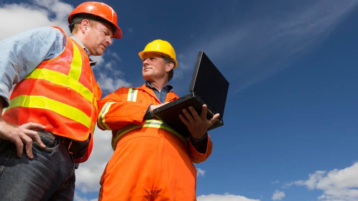 Miner and company person analysing results of a mining company.