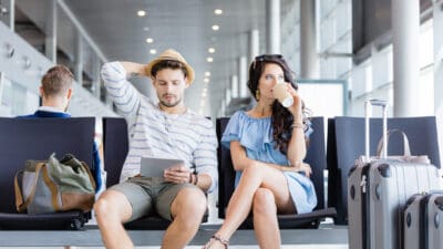 Couple at an airport waiting for their flight.