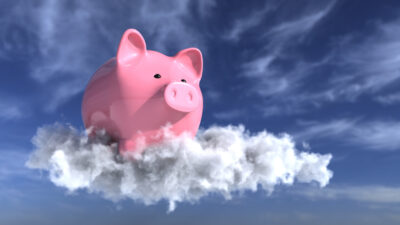 A piggy bank on the cloud in the blue sky symbolising a record high share price.