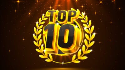 Fancy font saying top ten surrounded by gold leaf set against a dark background of glittering stars.