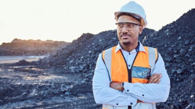 Coal miner standing in a coal mine.