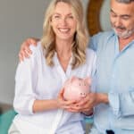 Couple holding a piggy bank, symbolising superannuation.