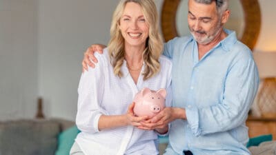 Couple holding a piggy bank, symbolising superannuation.