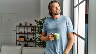 Middle age caucasian man smiling confident drinking coffee at home.