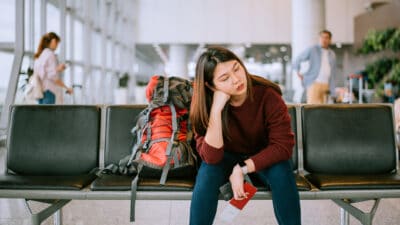 Bored woman waiting for her flight at the airport.