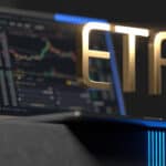 ETF in gold hovering on a laptop.