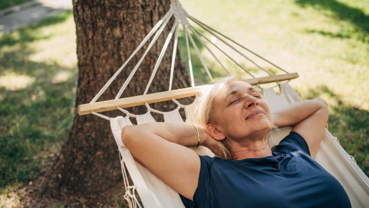 Woman in a hammock relaxing, symbolising passive income.