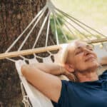 Woman in a hammock relaxing, symbolising passive income.