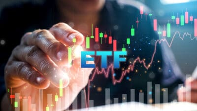 ETF in blue with person's hand in the direction of green and red bars on graph.