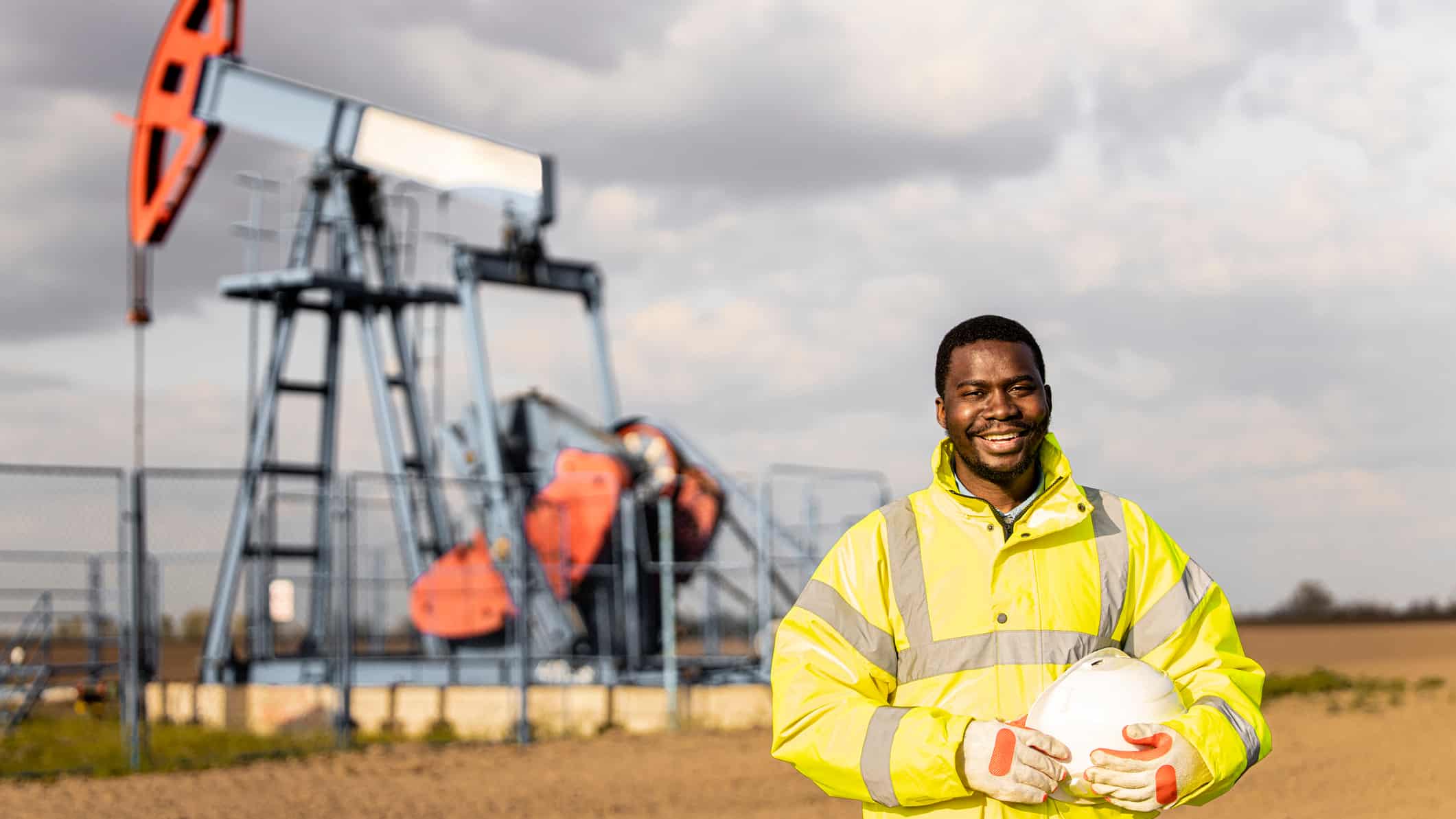 Smiling worker in an oil field.