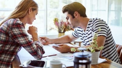 Two people comparing and analysing material.