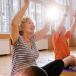 Group of retirees enjoying yoga, symbolising retirement.