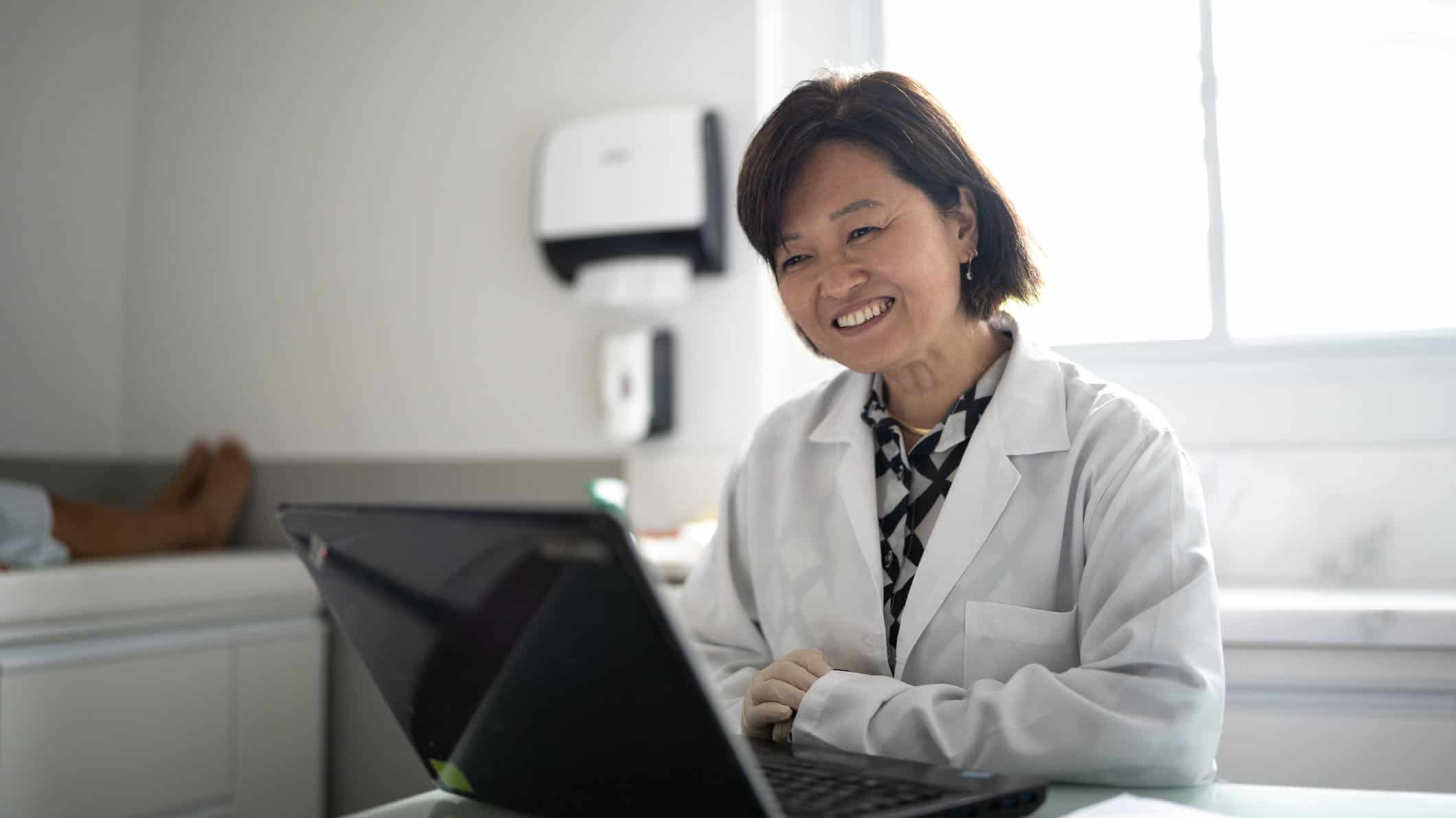 Doctor doing a telemedicine using laptop at a medical clinic