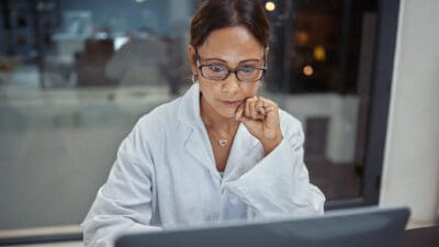 Shot of a mature scientists working on a laptop in a lab.