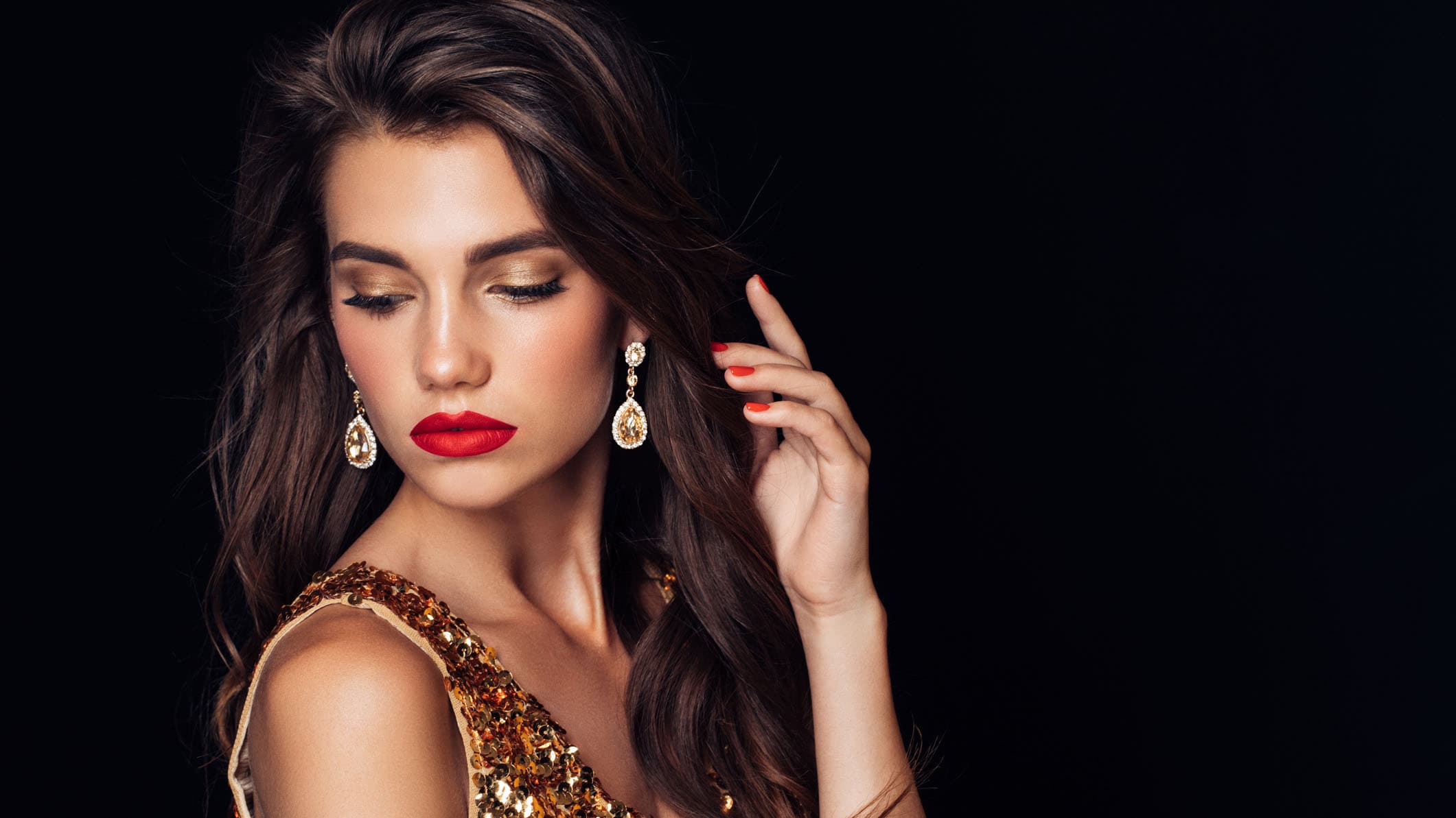 Girl with make up and jewellery posing.