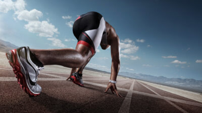 A view from the track behind a runner in the starting block.