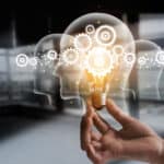 Innovation gears icon on a light bulb with network connection on human heads.