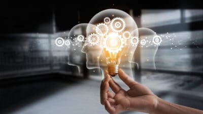 Innovation gears icon on a light bulb with network connection on human heads.