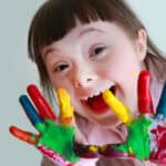 Girl with painted hands.