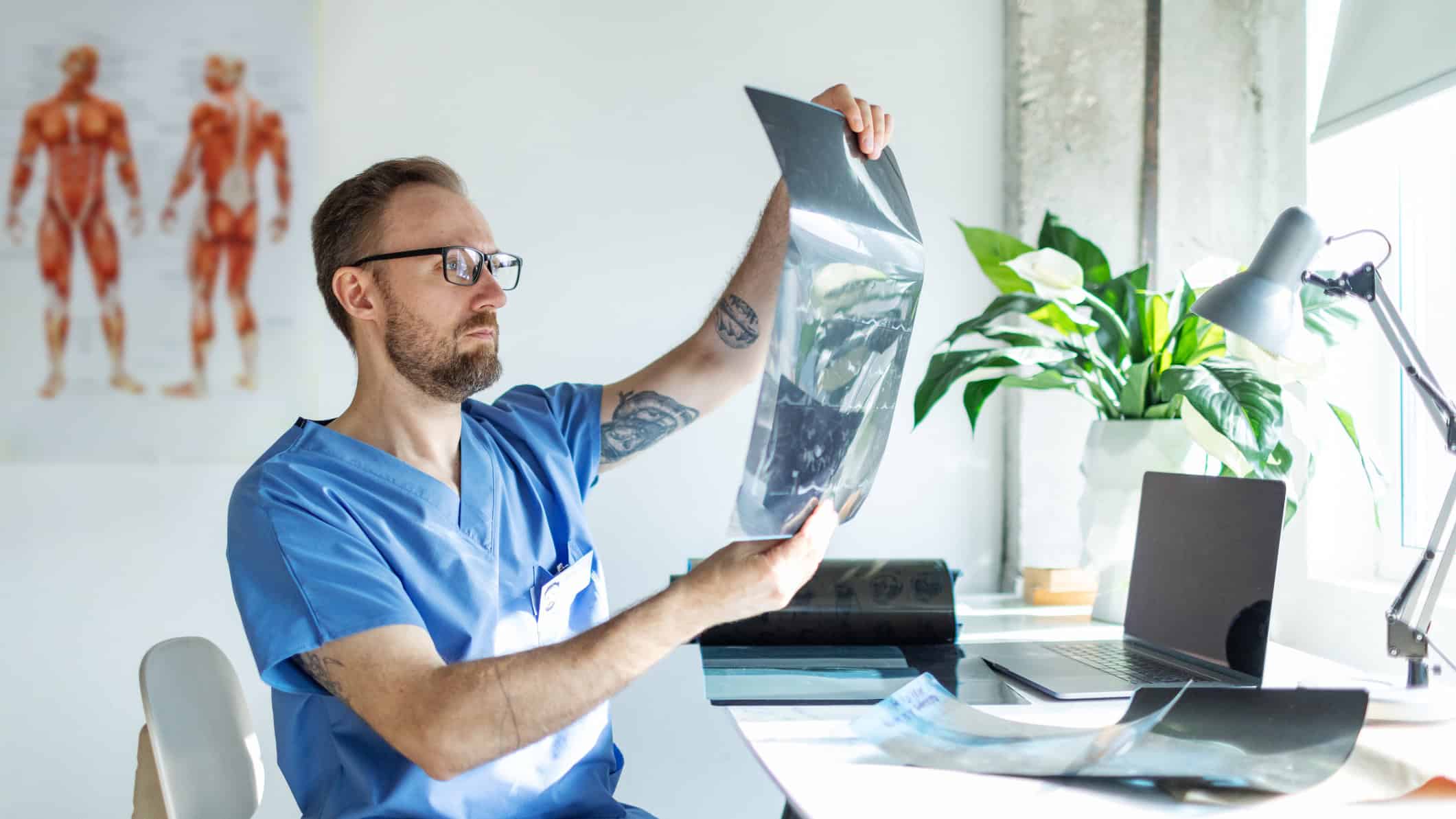 Doctor checking patient's spine x-ray image.