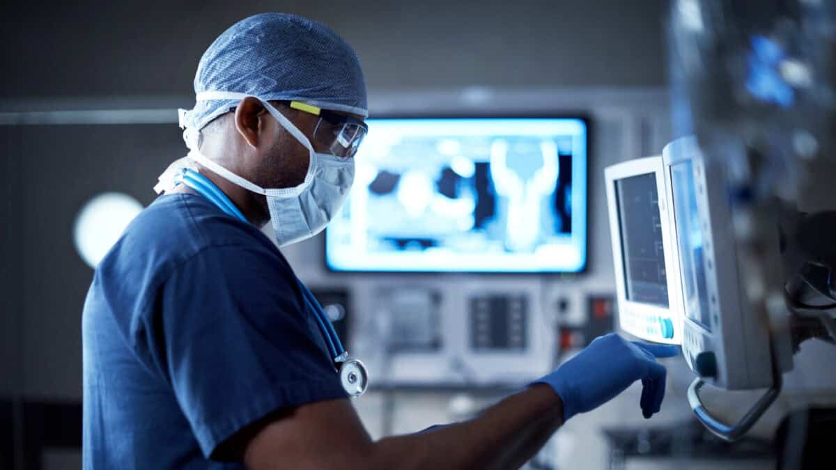Surgeon looking at a monitor in an operating room.