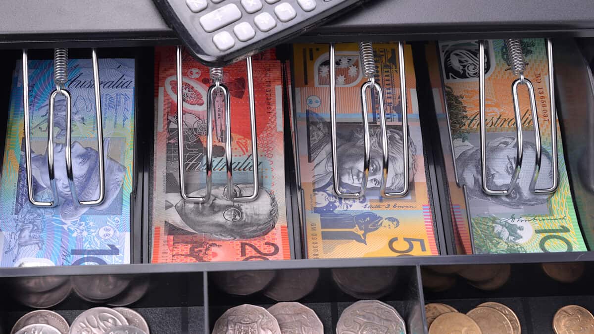 Australian dollar notes and coins in a till.