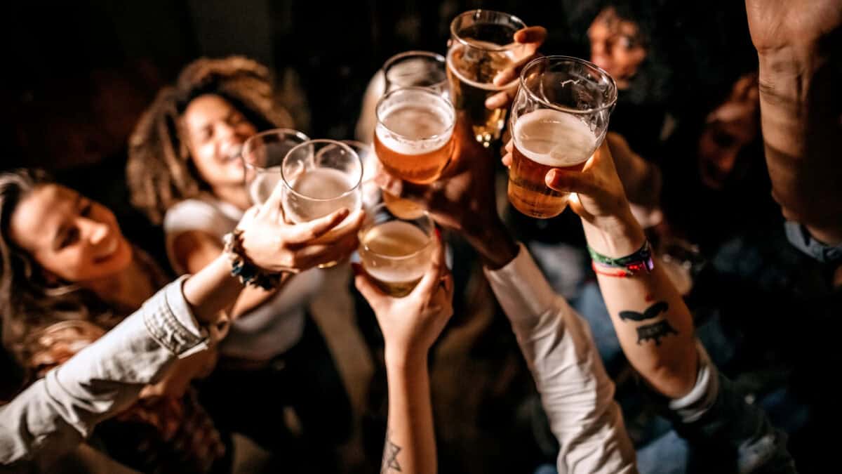 A group of friends cheering with beers.