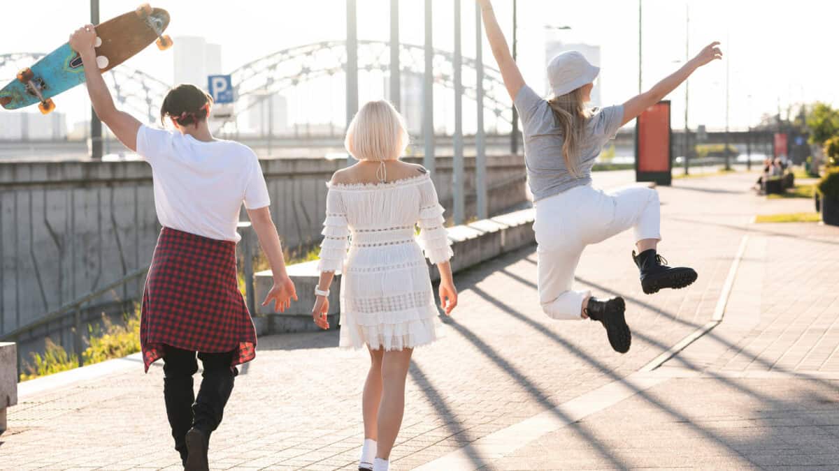 Three friends walking together and enjoying free time.