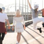 Three friends walking together and enjoying free time.