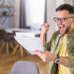 Man ecstatic after reading good news.
