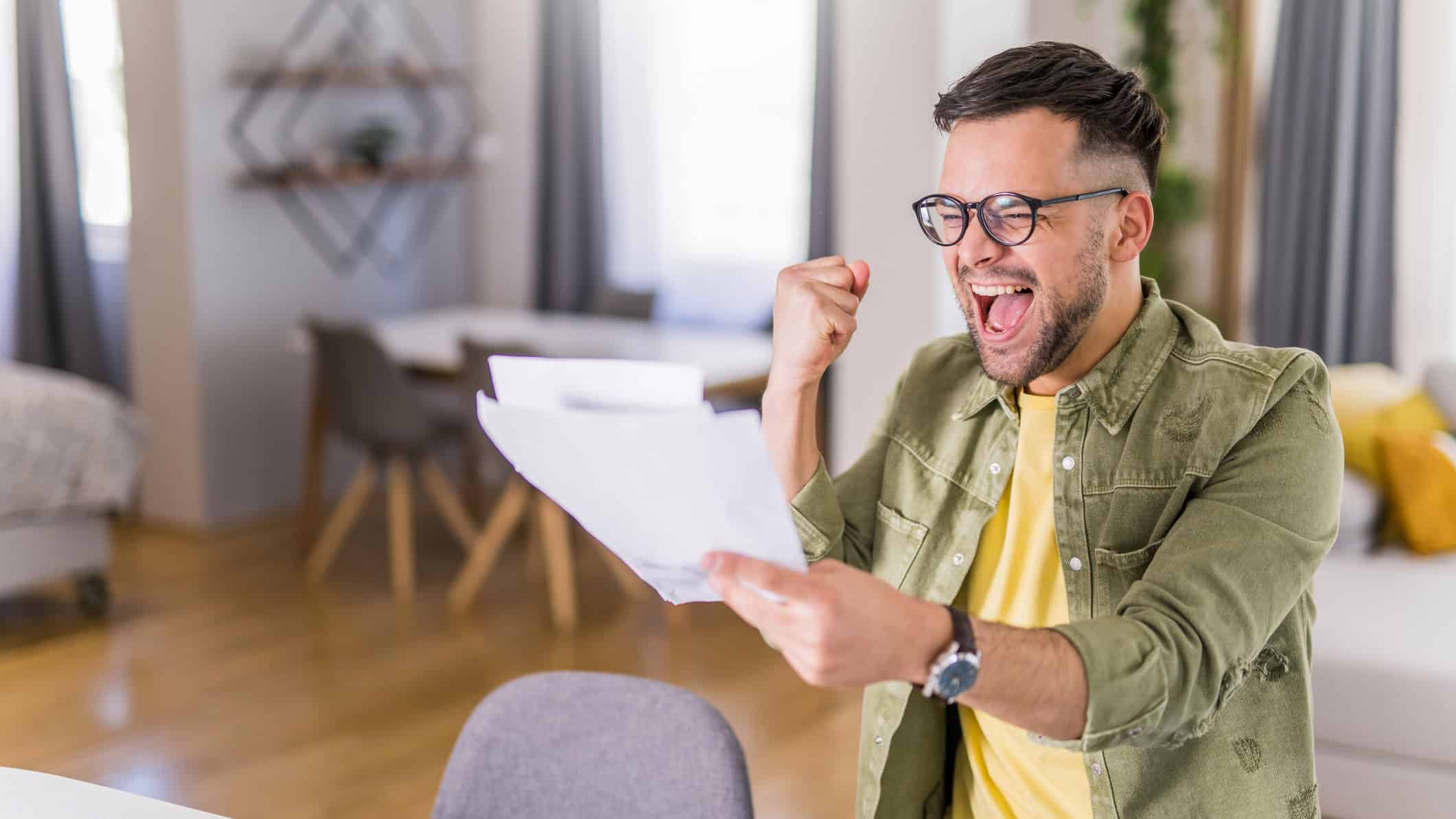Man ecstatic after reading good news.