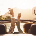 Happy young couple doing road trip in tropical city.
