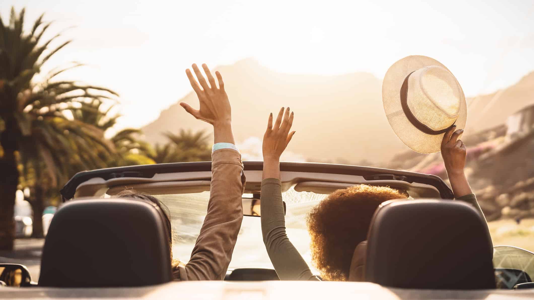 Happy young couple doing road trip in tropical city.