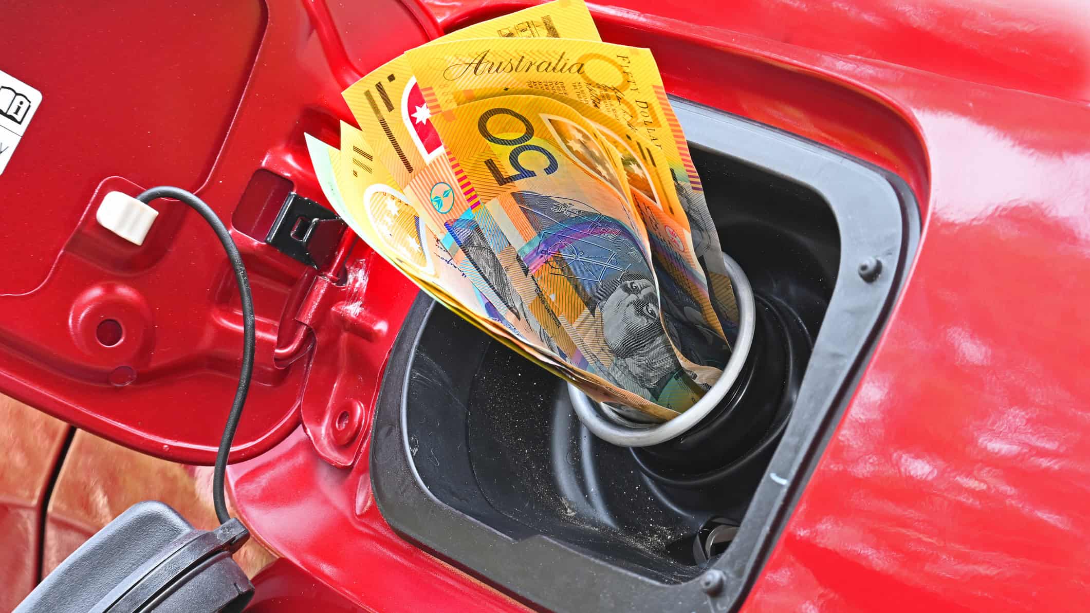 $50 dollar notes jammed in the fuel filler of a car.
