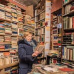 Woman going through a book in a book shop.