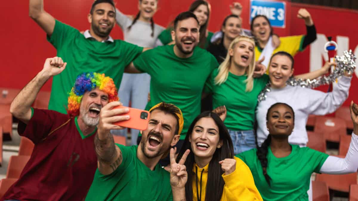 Fans are cheering for their team at a stadium.