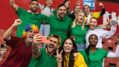 Fans are cheering for their team at a stadium.