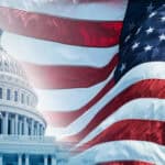 American flag next to United States Capitol building.