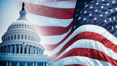 American flag next to United States Capitol building.