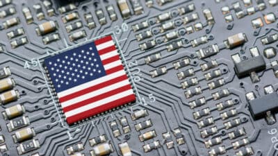 Flag of USA on a processor, CPU Central processing Unit, or GPU microchip on a motherboard.
